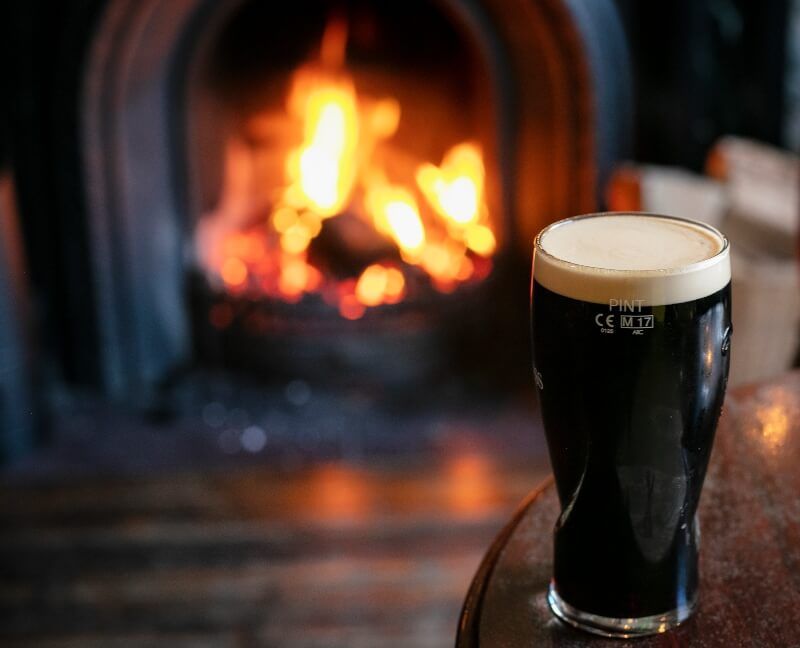 Irish Pint of Guinness by the lit open fire at Reception Lobby